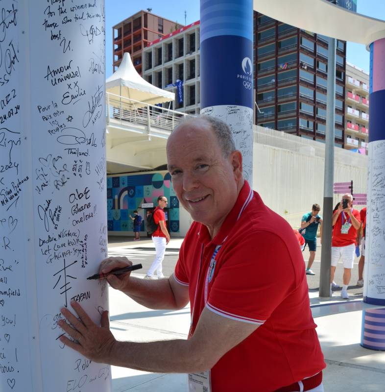 Prince Albert II signing the Peace Wall in the Olympic village